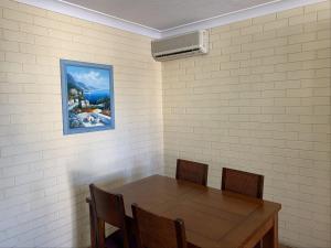 a dining room table and chairs in a room at Harbour Side Resort in Gold Coast