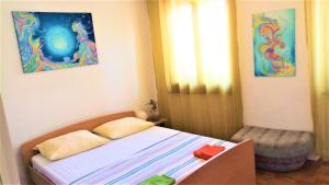 a bedroom with a bed and a painting on the wall at Sonce in Izola