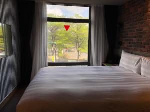 Postel nebo postele na pokoji v ubytování City Suites - Kaohsiung Pier2