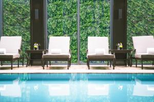 
a living room filled with furniture and a pool at Pullman Shanghai Jingan in Shanghai
