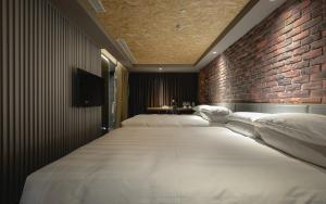 Postel nebo postele na pokoji v ubytování City Suites - Kaohsiung Pier2