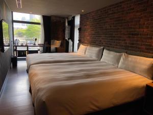 Postel nebo postele na pokoji v ubytování City Suites - Kaohsiung Pier2