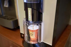 a coffee maker with a glass container with a drink in it at NAHA-WEST INN in Naha