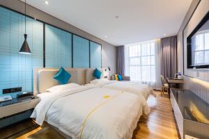 Postelja oz. postelje v sobi nastanitve Warm Yes Business Hotel -Free shuttle bus during the Canton Fair