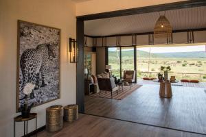 a living room with a view of the desert at Shamwari Sindile in Paterson