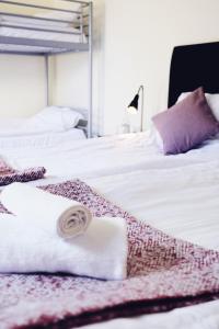 a bedroom with two beds with towels on them at Kågeröds Värdshus Tre Stjärnor in Kågeröd