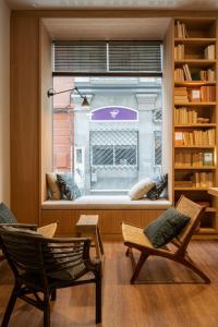 a room with two chairs and a large window at Toc Hostel Granada in Granada +83 photos