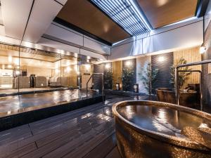 a large bathroom with a tub in the middle at APA Hotel Shin Osaka Ekimae in Osaka