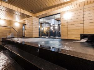 a dance floor in a building with a pool of water at APA Hotel Shin Osaka Ekimae in Osaka