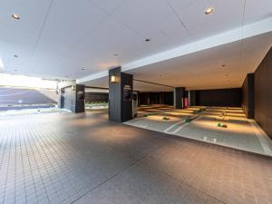 a lobby of a building with a tile floor at APA Hotel Shin Osaka Ekimae in Osaka
