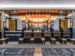 a bar with tables and chairs in a room at APA Hotel Shin Osaka Ekimae in Osaka