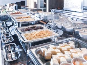 a buffet line with trays of food on display at APA Hotel Shin Osaka Ekimae in Osaka