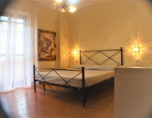 ein Schlafzimmer mit einem Bett in einem Zimmer mit einem Fenster in der Unterkunft Appartamento Tropea Dario in Tropea