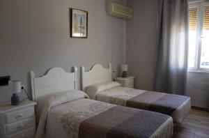 Postel nebo postele na pokoji v ubytování Hostal Casa Jose