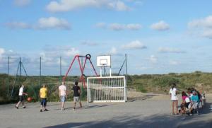 a group of people standing around a soccer goal at CVJM Freizeithaus MS Waterdelle in Borkum