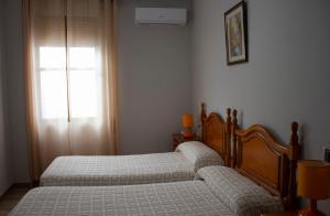 Postel nebo postele na pokoji v ubytování Hostal Casa Jose