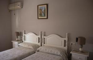 Postel nebo postele na pokoji v ubytování Hostal Casa Jose
