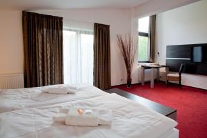 Postel nebo postele na pokoji v ubytování Hotel Zámecká Sýpka