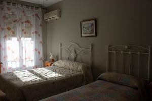Postel nebo postele na pokoji v ubytování Hostal Casa Jose