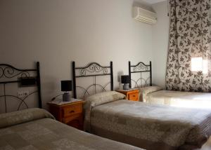 Postel nebo postele na pokoji v ubytování Hostal Casa Jose