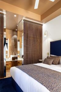 a hotel room with a large bed and a bathroom at Luxurious by Sebastiana Group in San Sebastián