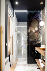 a bathroom with a shower with a glass door at Luxurious by Sebastiana Group in San Sebastián