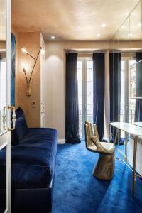 a living room with a blue couch and a table at Luxurious by Sebastiana Group in San Sebastián