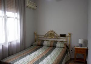Postel nebo postele na pokoji v ubytování Hostal Casa Jose