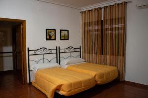 Postel nebo postele na pokoji v ubytování Hostal Casa Jose