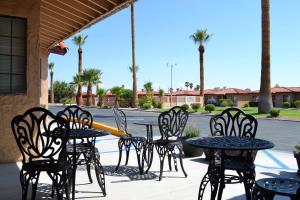 a group of chairs and tables in a patio at El Rancho Dolores at JT National Park in Twentynine Palms