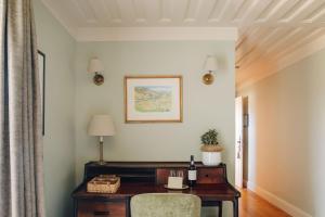 a room with a wooden desk and a chair at Quinta Nova Winery House - Relais & Châteaux in Pinhão