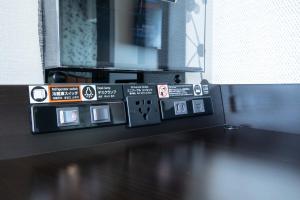 a bunch of signs on the side of a room at APA Hotel Shin Osaka Ekimae in Osaka