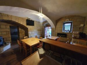 a dining room with a wooden table and chairs at Chalupa Vesec in Vesec