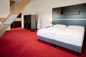 Postel nebo postele na pokoji v ubytování Hotel Zámecká Sýpka