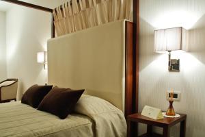 Postel nebo postele na pokoji v ubytování Hotel Del Campo