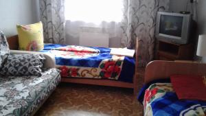 A bed or beds in a room at Guest House Angarskie Khutora