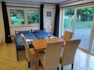 a dining room with a table and a couch at Guest House Ons Hoekje in Houten