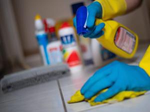 a person using a pair of gloves to clean a floor at Tatra 4 Studios in Budapest