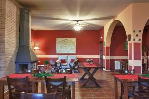 un restaurant avec des tables, des chaises et une cheminée dans l'établissement Villa Romana- hasta 24 personas, à Don Álvaro