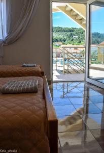 a living room with a couch and a balcony at Galeb in Veli Iž