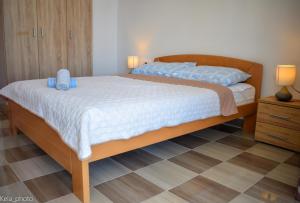 a bedroom with a large bed with blue pillows on it at Galeb in Veli Iž
