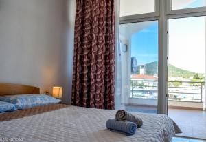 a bedroom with a bed and a large window at Galeb in Veli Iž