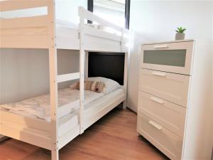 ein weißes Etagenbett in einem Zimmer mit einer Kommode in der Unterkunft 2minBikepark&Ski - Loft Lotte - bikes lockable in Winterberg