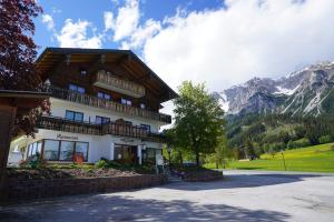 a large building with mountains in the background at Sinabell by Schladmingurlaub in Ramsau am Dachstein