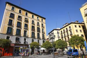 a city street with two tall buildings and a blue van at Paloma by Madflats Collection in Madrid