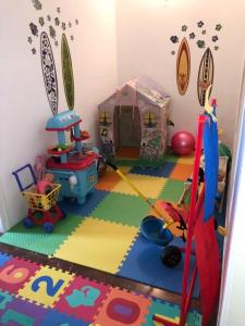 a childs play room with a play set and toys at Villa Cullinan in Kokóni
