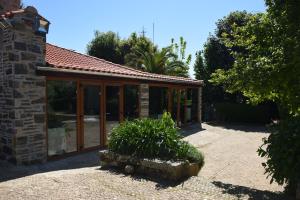 a house with sliding glass doors and a courtyard at Quinta da Boa Ventura in Bragança