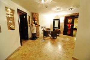 a man standing in a living room with a table at Silivri Park Hotel in Silivri