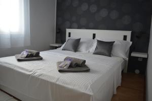 Posteľ alebo postele v izbe v ubytovaní Apartmani Sidro