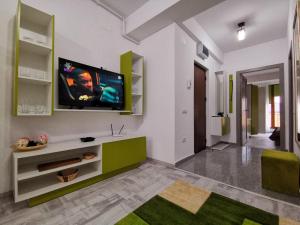 a living room with a flat screen tv on a wall at Green Apartment- Brilliant Apartments in Constanţa